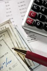 Fototapeta premium Close up of checks, pen and calculator