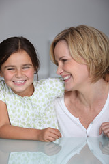 A daughter and her mother laughing together.