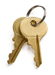 A pair of gold keys isolated on white background.