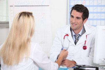 Smiling doctor taking patient's card