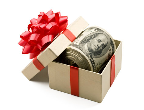Holiday bonus. Money roll in gift box with red bow.