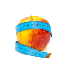 red apple and measuring tape on white background