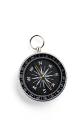 Close up of a compass with soft shadow on white background.