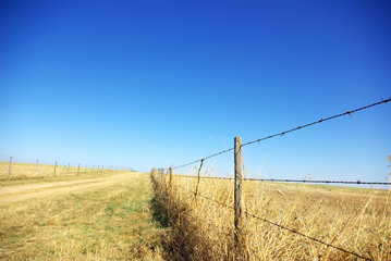 Barbed wire fence with blue sky at Portugal.