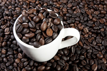 coffee cup, coffee beans in a ceramic cup close-up.