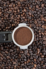 grounded coffee in a scoop on coffee bean wallpaper.