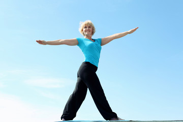 Fototapeta premium Portrait of a senior woman doing yoga