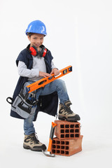 Small girl pretending to be construction worker