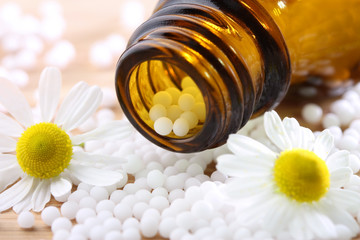 Obraz na płótnie Canvas Homeopatyczne leki z globulek rumianku