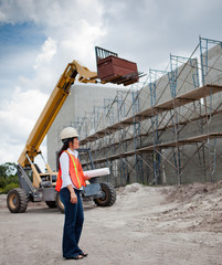Asian Woman Inspector on construction site.