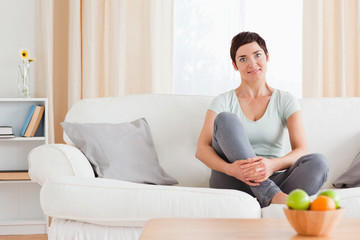 Cute woman sitting on a sofa