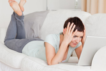 Unhappy woman using a laptop