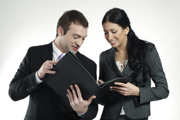 businessman and businesswoman looking at portfolio