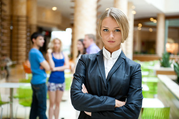 Portrait of a cute business woman with colleagues at the backgro