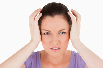 Fototapeta premium Portrait of a good looking woman having a headache while standin