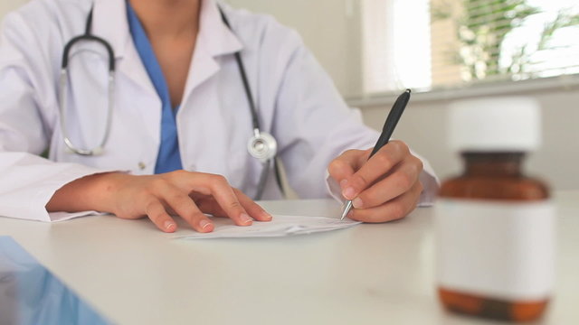 Young doctor writing a prescription