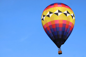 Fototapeta premium Hot air balloon against blue sky background