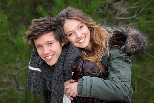 Happy Smiling Winter Teen Couple In Piggy Back