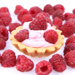 Tartlet with whipped cream and raspberries on white