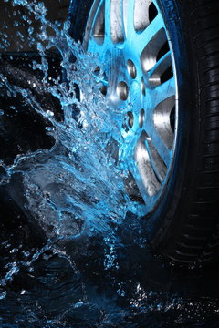 Car's wheel  with blue water