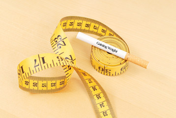 Cigarette on Top of Tape Measure Roll