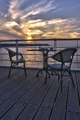Chairs in restaurant during the sunset