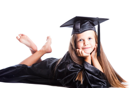 Cute little girl in graduation dress on isolated white