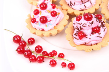 Tartlets with whipped cream, fruits and sprinkles