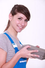 handywoman holding tiles