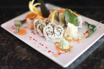 Plate of sushi with garnish