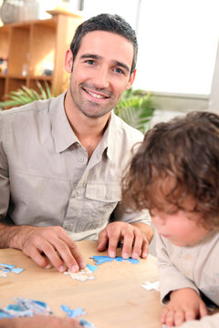 Father and child with jig-saw puzzle