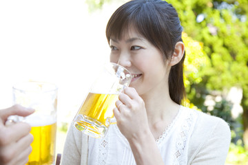 庭でビールを飲む女性