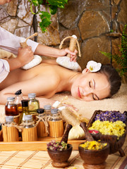 Woman getting thai herbal compress massage . - 33939877