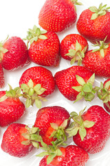lots of fresh strawberries against white background