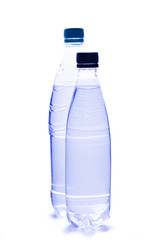 Plastic bottles of water on white background