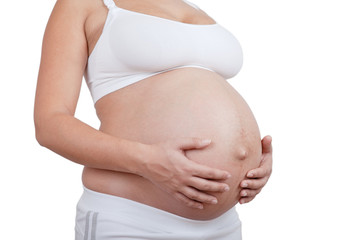 Pregnant woman hold hands on a belly