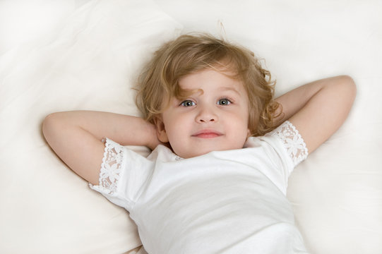 Adorable little girl resting in the bed