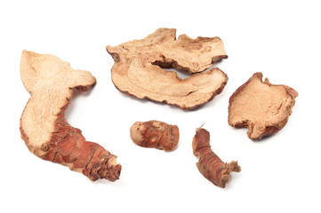 Dried slices of galangal on white background
