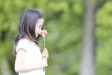 花の匂いを嗅ぐ女の子