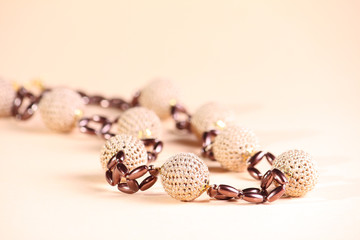 Brown beads at pink background