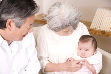 孫娘をあやす祖父と祖母