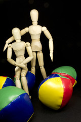 humanoid couple hugging with juggling balls in bright colors