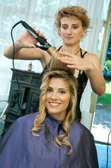 woman in hair salon having hair curled
