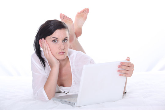 Startled woman using her laptop