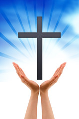 Hand holding a Cross