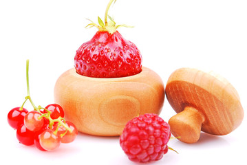 Blackcurrant, raspberry and strawberry close-up, wooden bowl