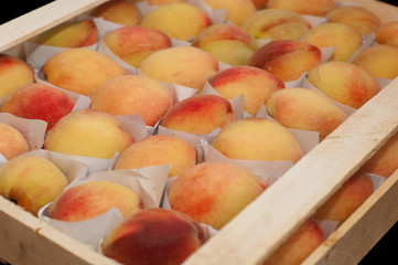 Fresh peaches in a box. Closeup
