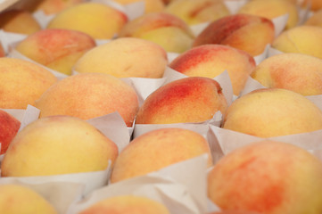 Fresh peaches in a box. Closeup