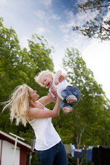Mother Throwing Son in Air
