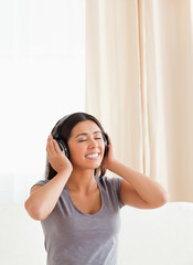 Naklejka premium charming woman with closed eyes and earphones
